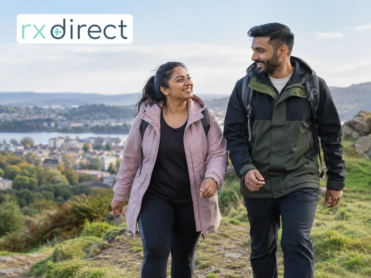 Couple walking up a gentle outdoor slope, with the RX Direct logo